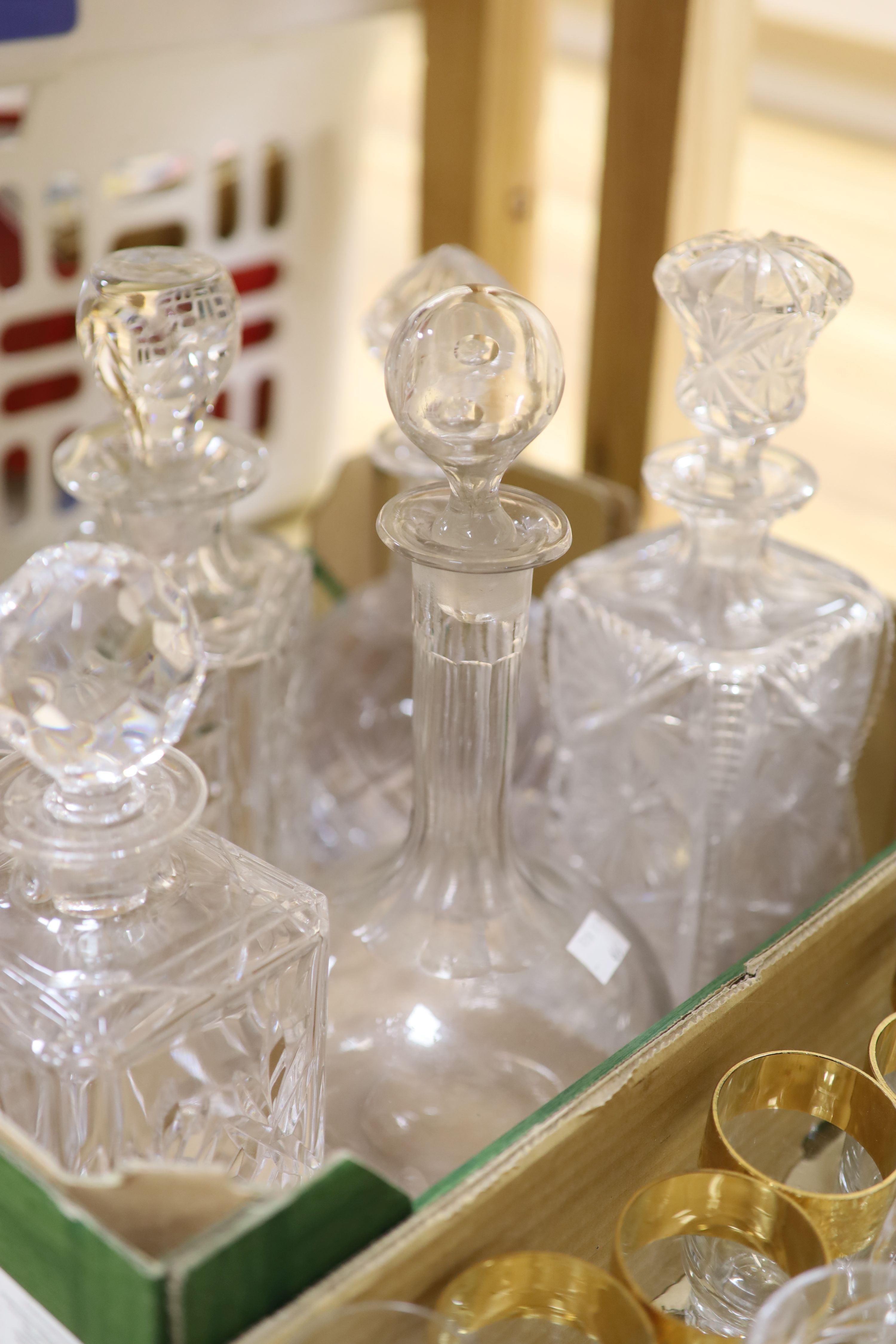 Eight cut glass decanters and mixed drinking glasses